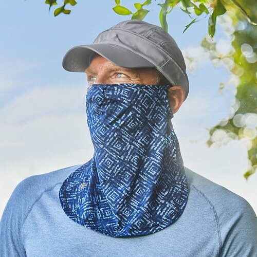 Man in blue gaiter and cap outdoors